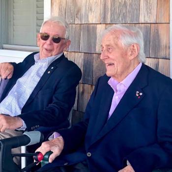 THB Symons sitting with a colleague.