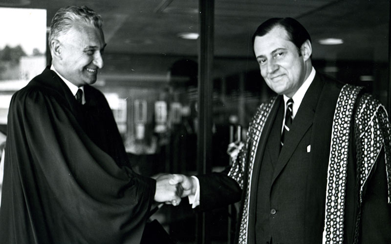 Tom H.B.Symons shaking hands