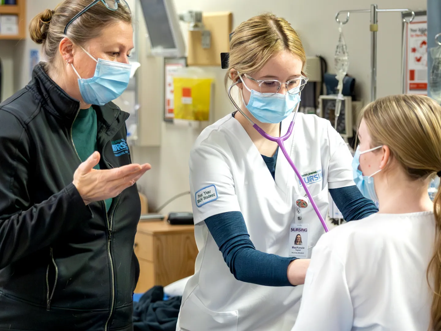 Nursing students get guidance from a lab demonstrator