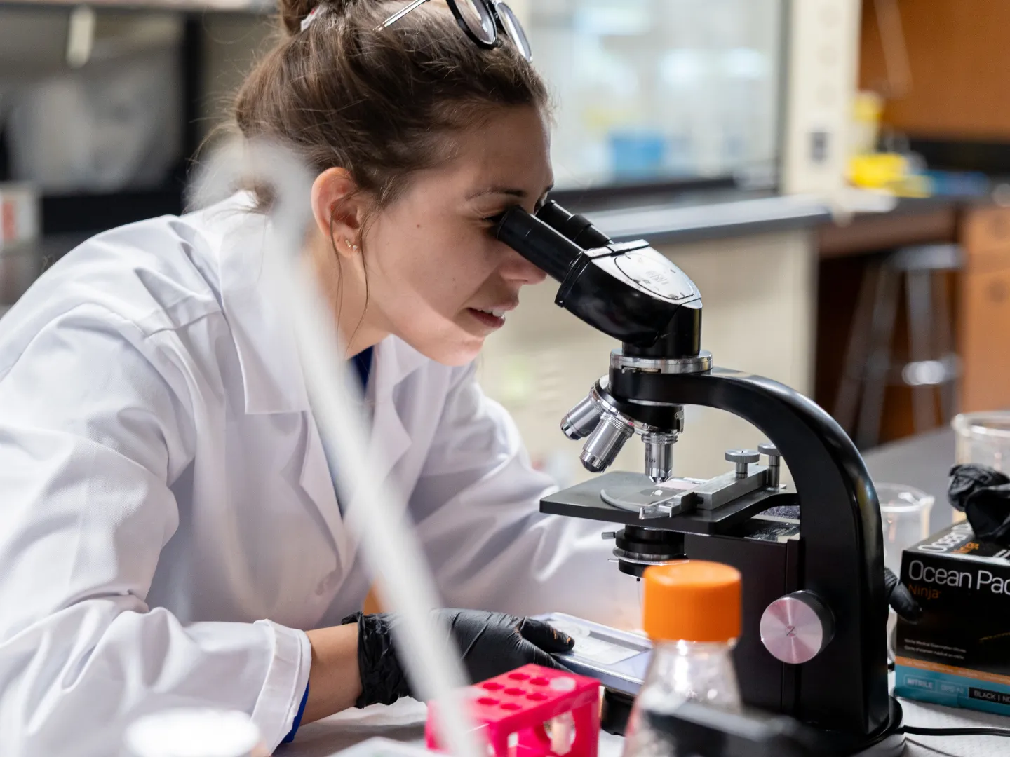 Student using microscope in lab