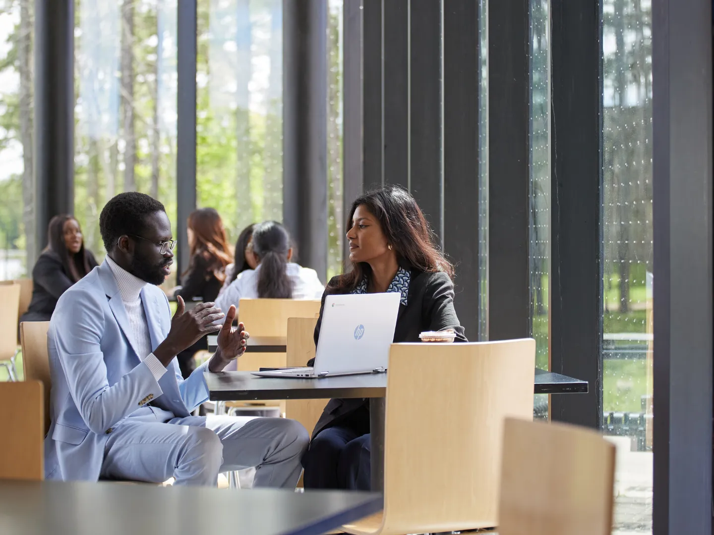 Two business students talking in the student centre.