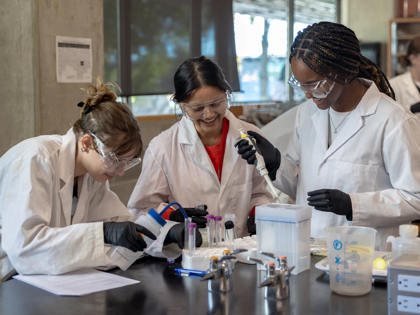 Students in labs using pipettes.