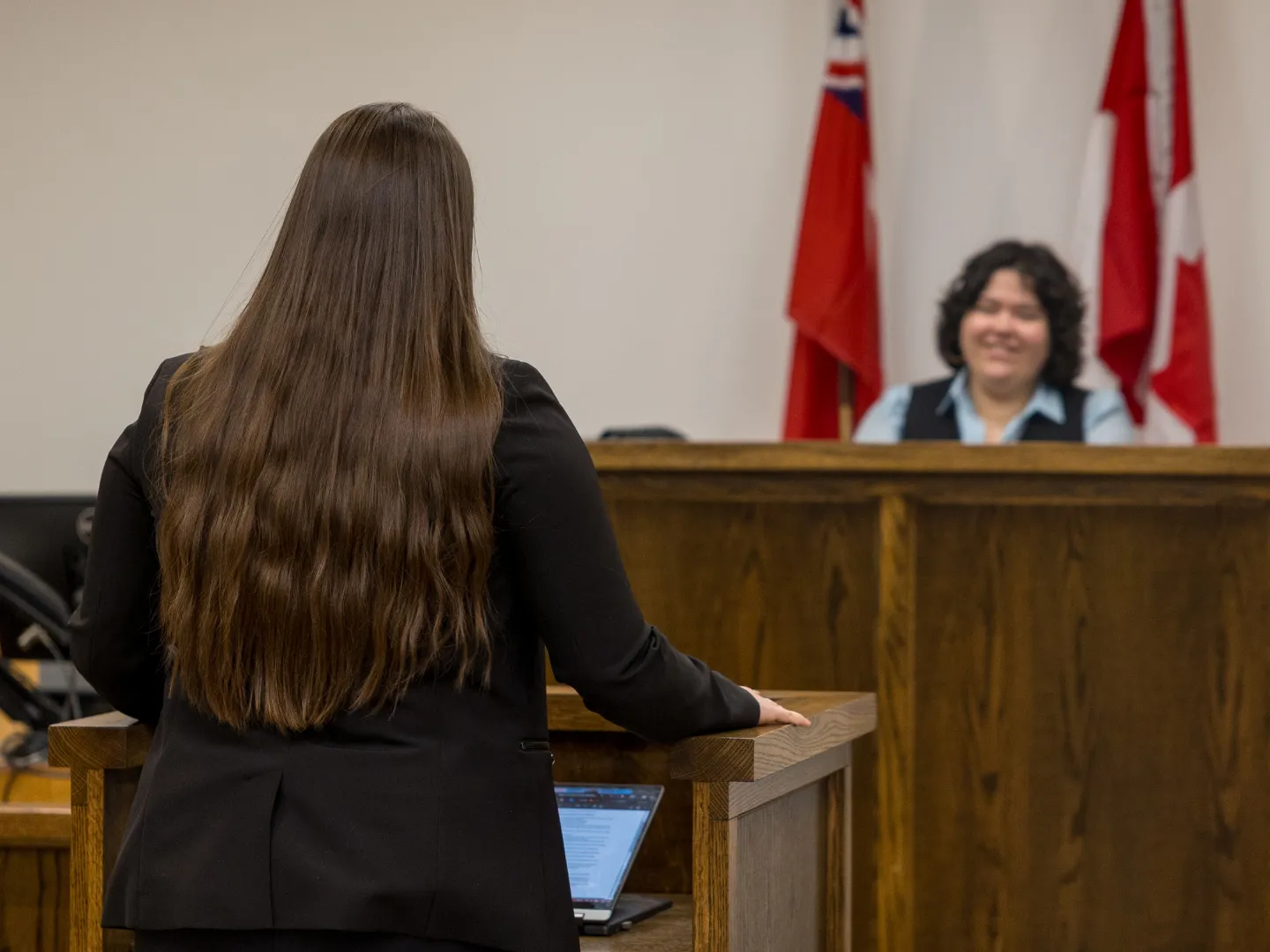 Student being a lawyer in mock trail talking to judge.