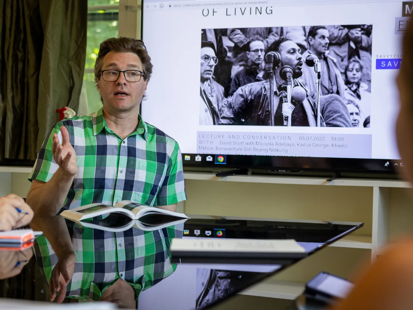 Cultural studies professor talking to students in seminar.