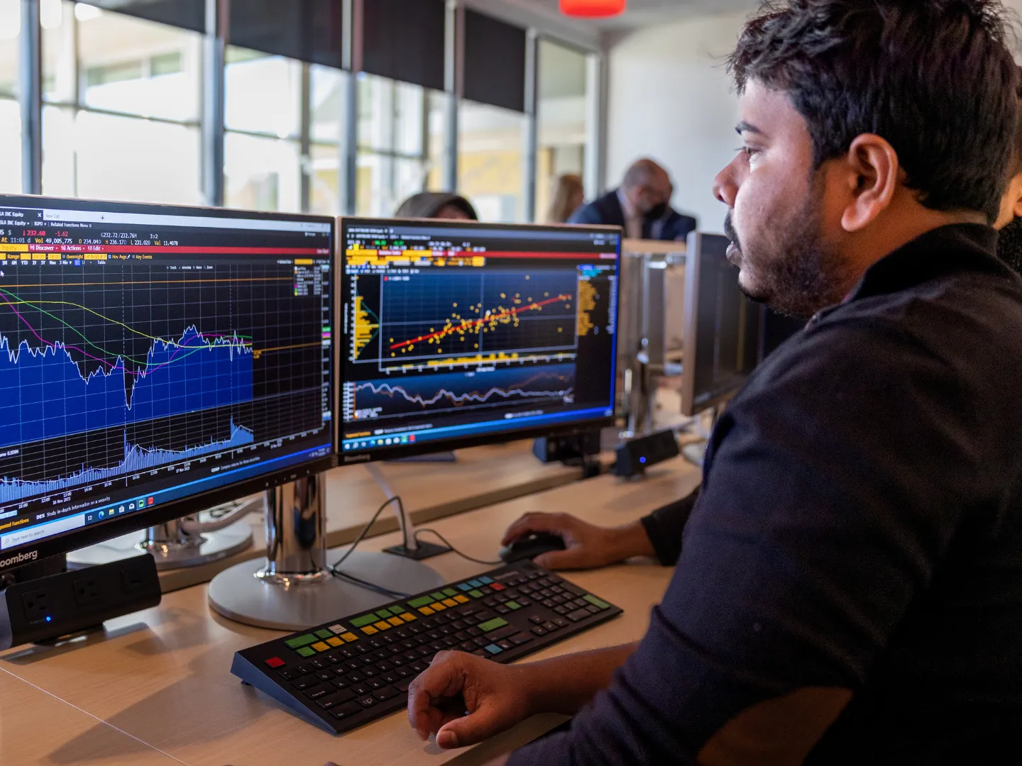 Student working on Bloomberg financial terminals in Trent University's Financial Intelligence & Innovation Hub