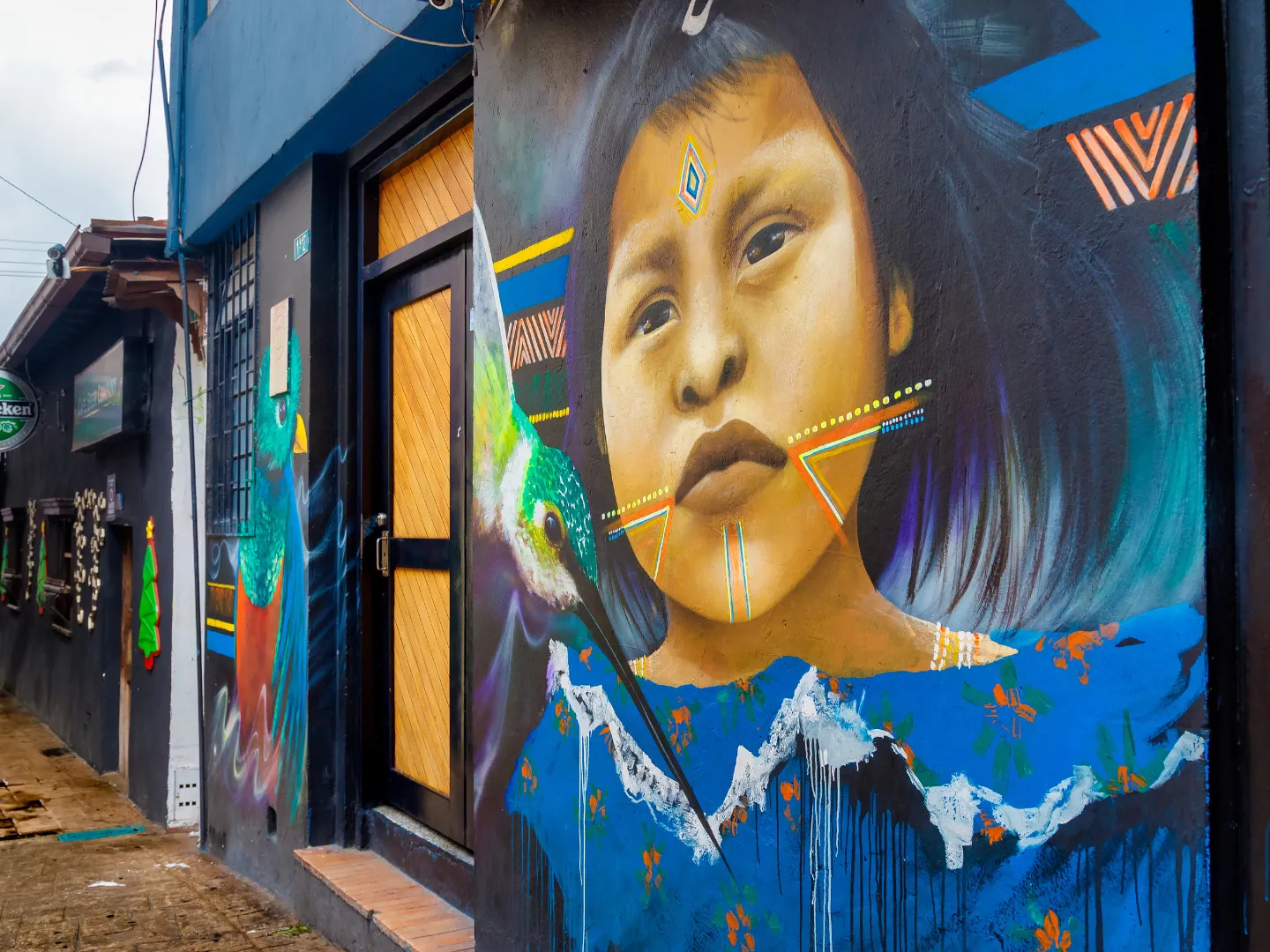 Painted mural of a child's face on building.