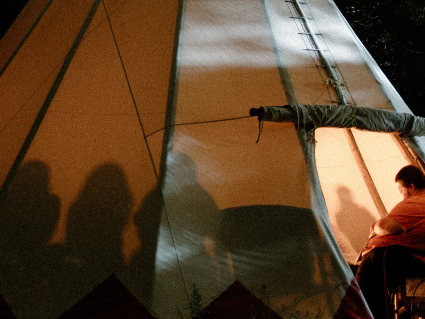 Group talking inside of tipi.