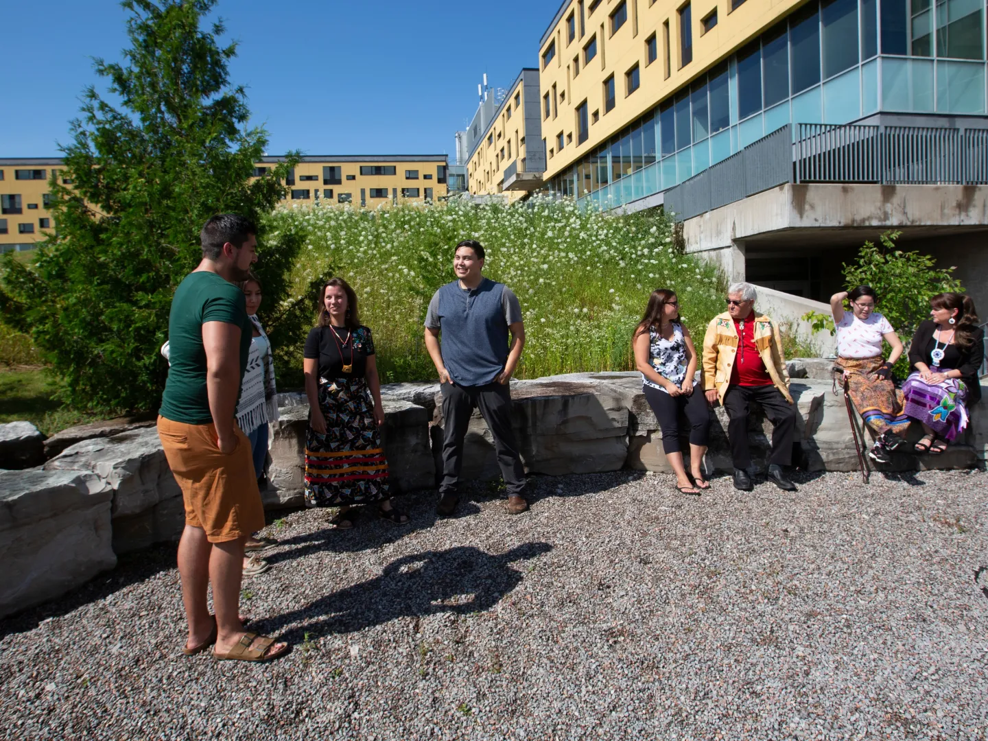 Staff and students from FPHL talking outside.