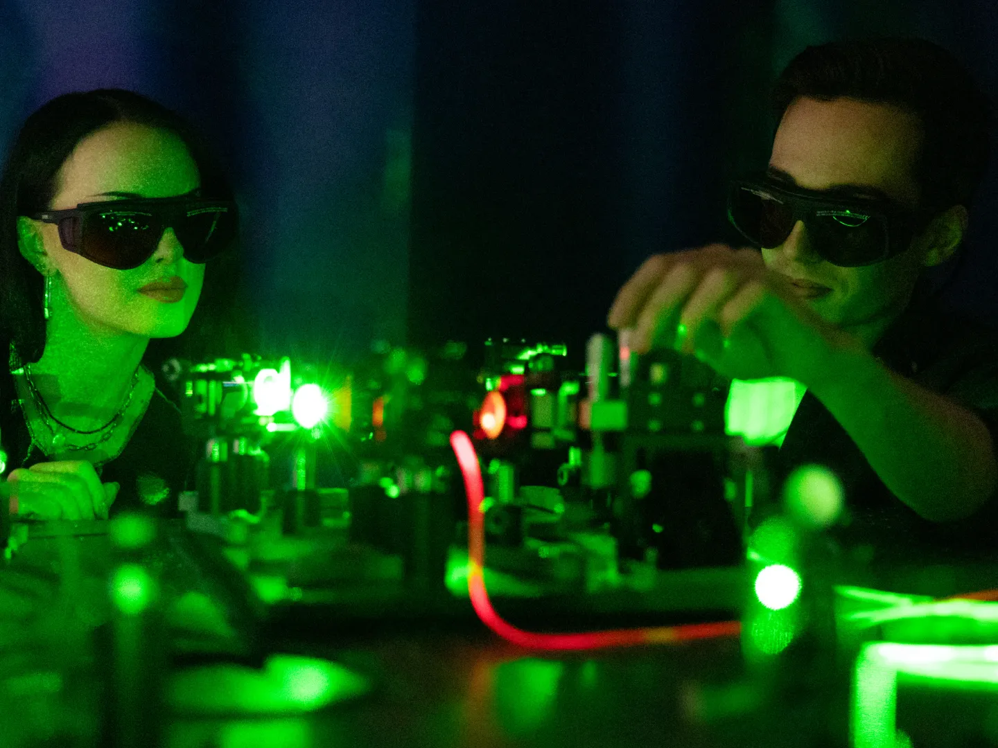 Students in lab using lasers.