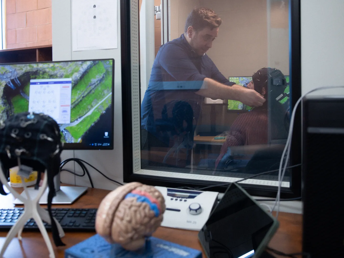 Dr. Sebastian Paquette research on Psychology Brain, using EEG cap on participant.
