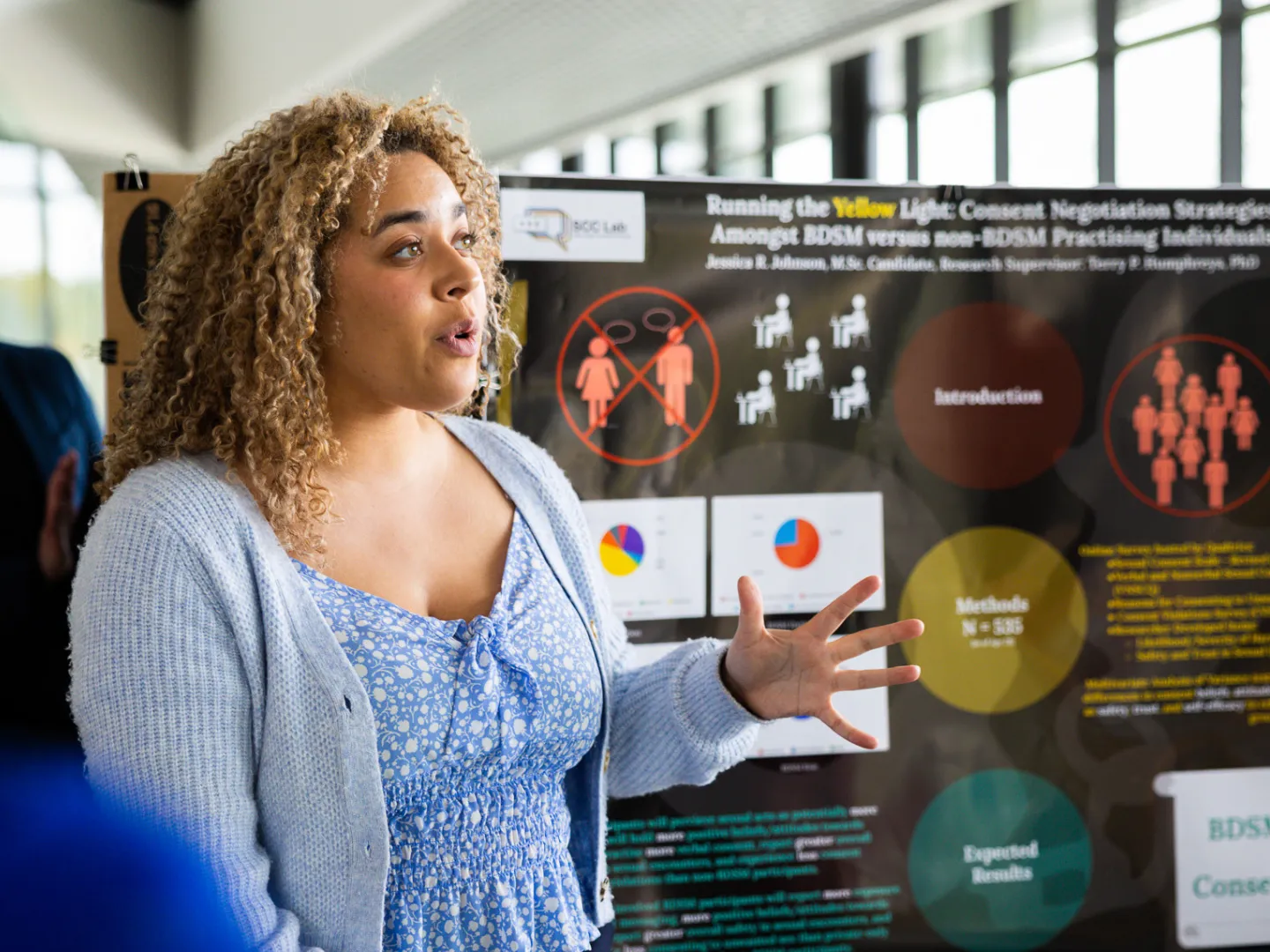 Psychology M.Sc. student presenting research poster.