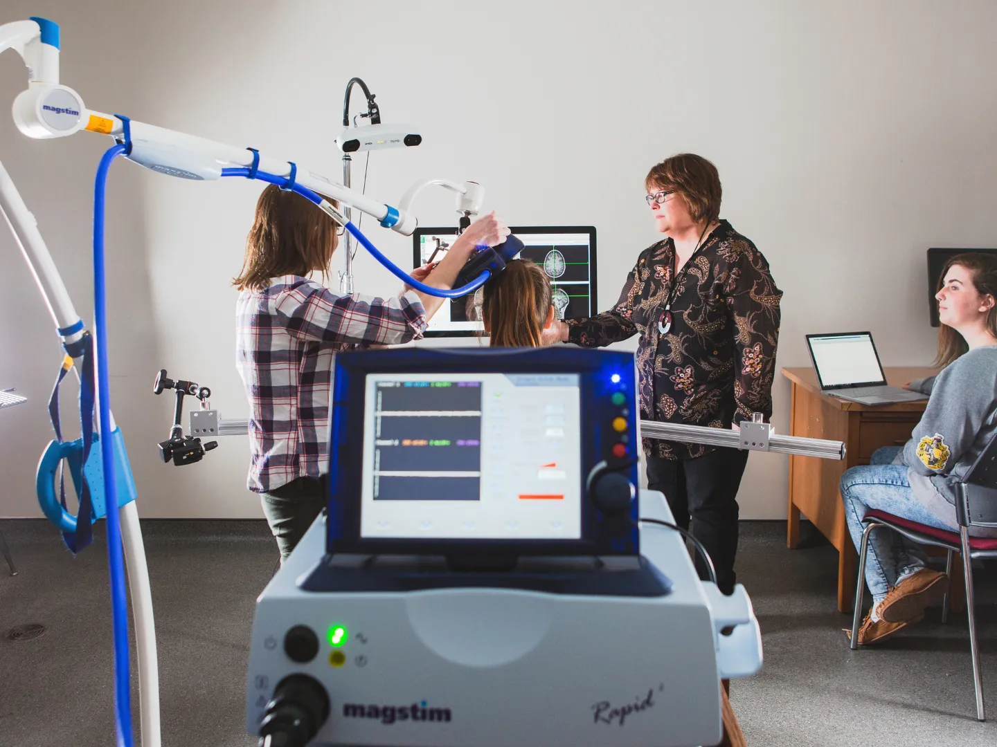 Researchers using brain scan equipment.