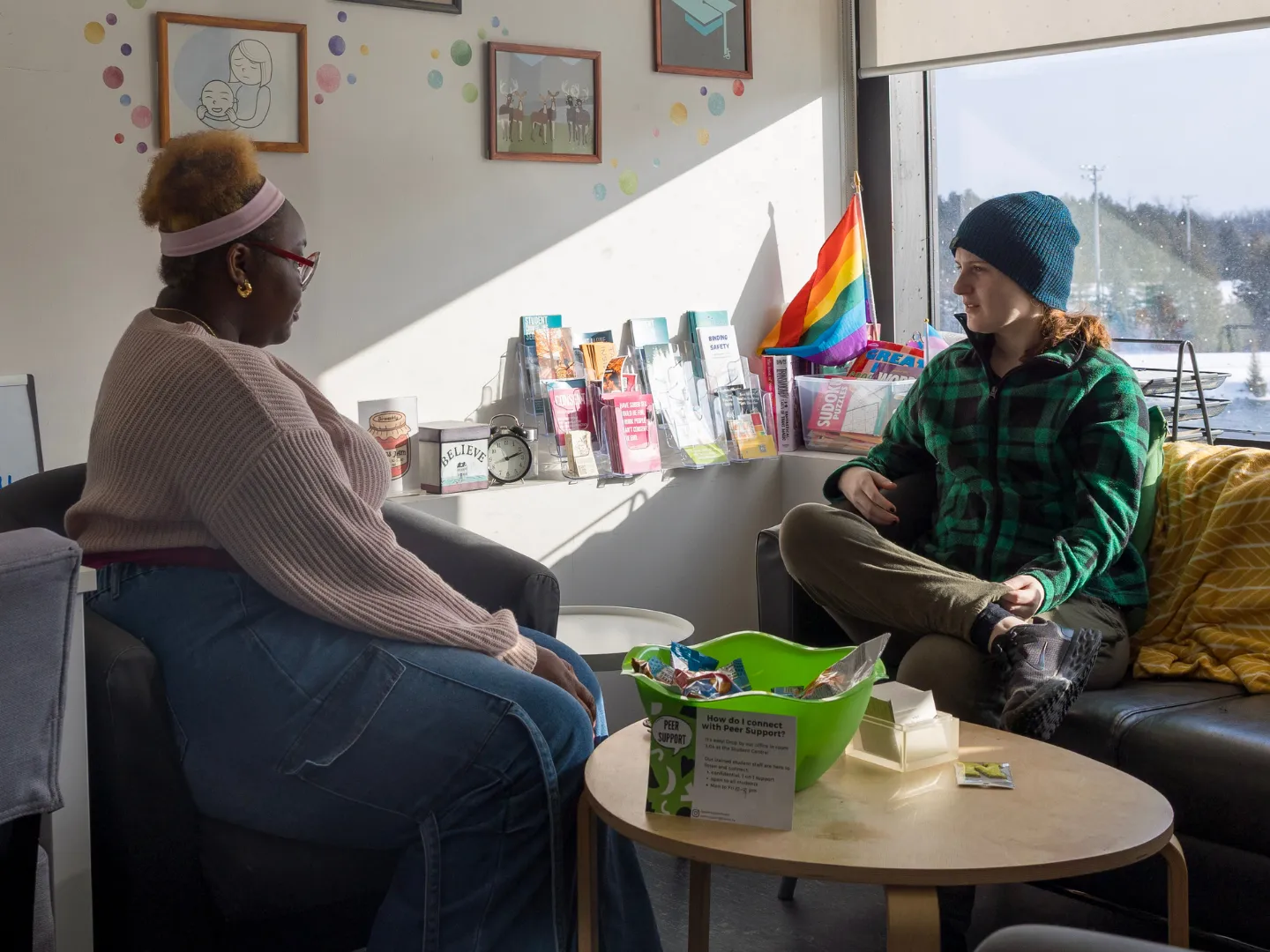Trent peer support students talking to each other in office.
