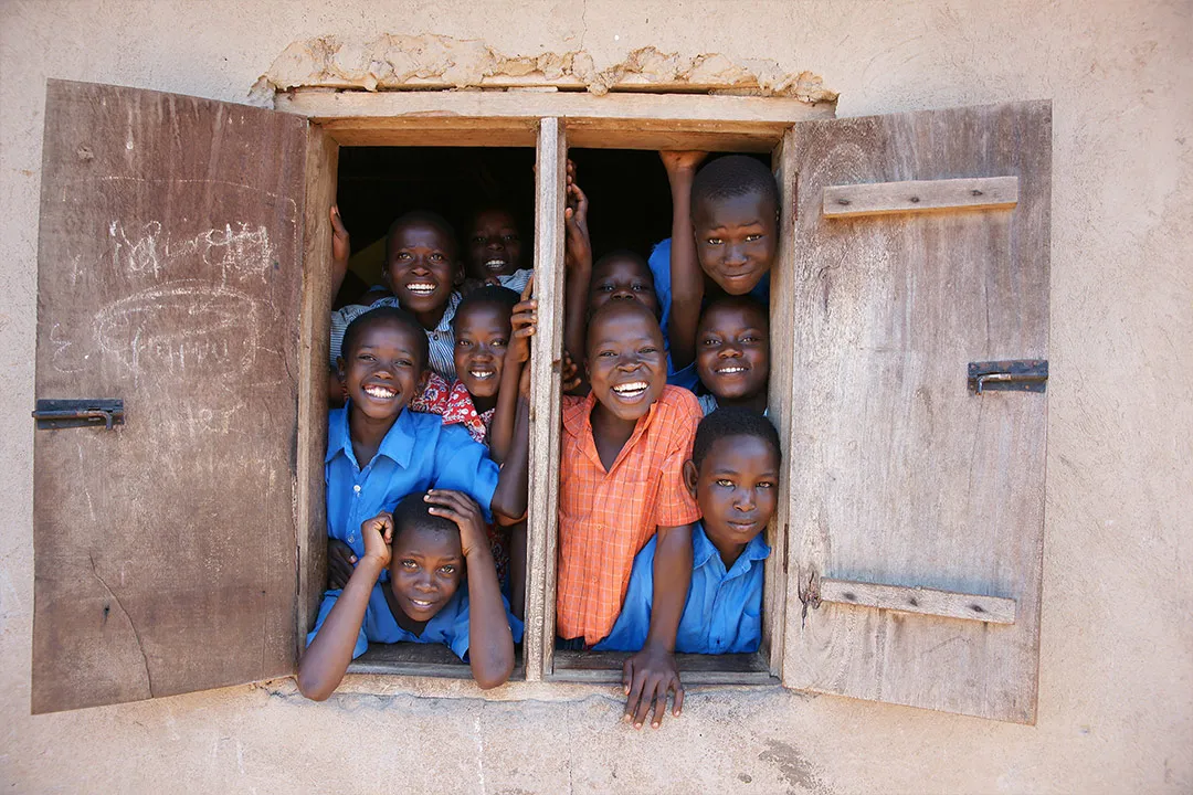 Children look out from a window