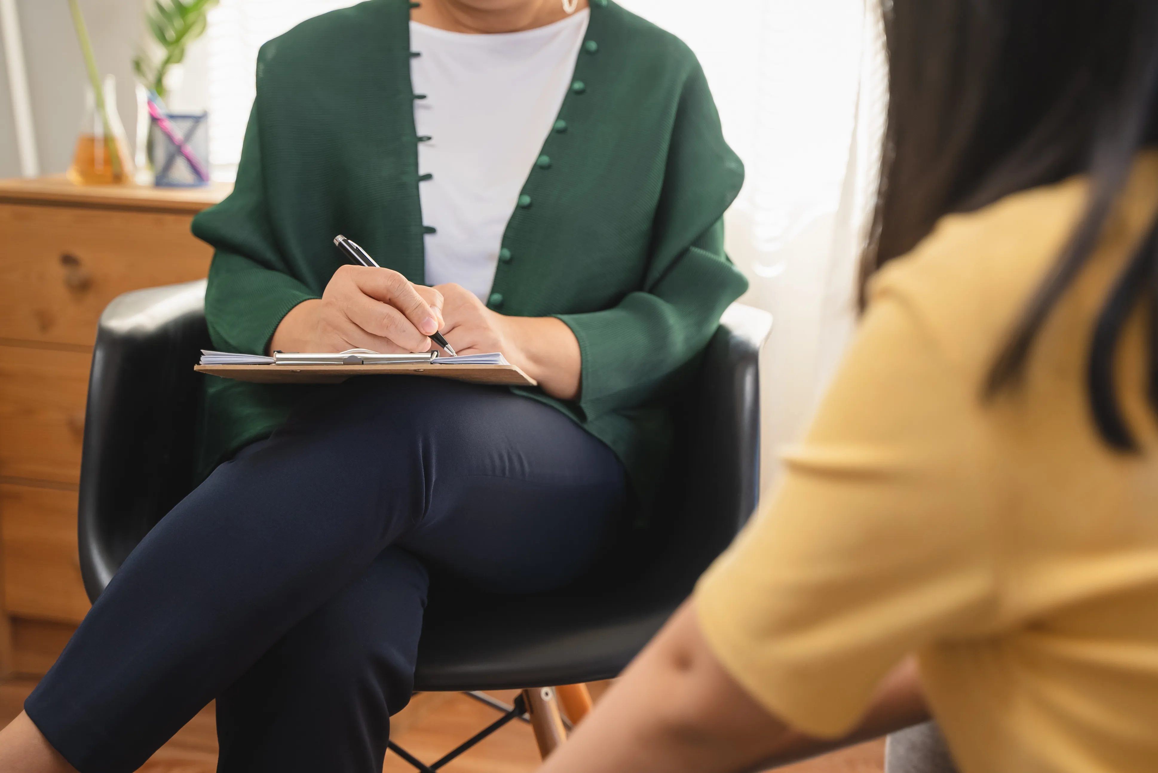 Person in a therapy session talking with a psychologist in the office.