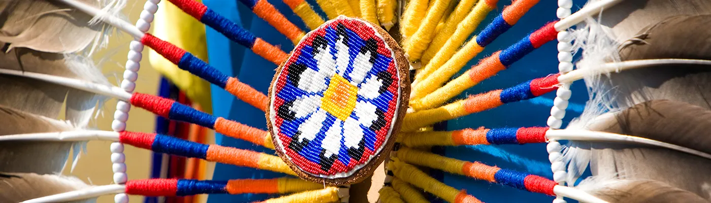 A close up of a handmade dream catcher made of colourful beads