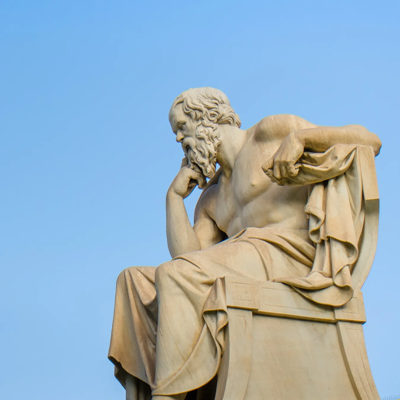 Ancient marble statue of the great Greek philosopher Socrates on background the blue sky