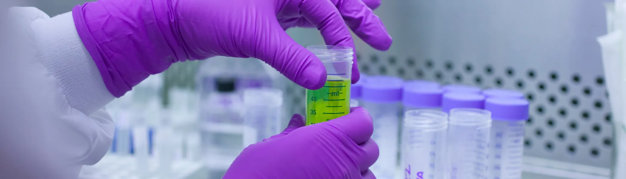 Student in lab handling chemicals.