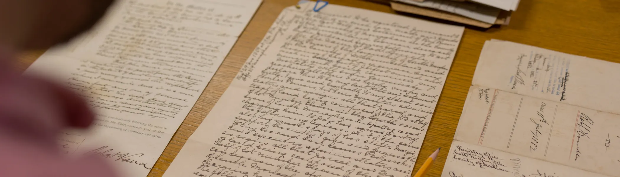 Trent University student looking at archival notes. 