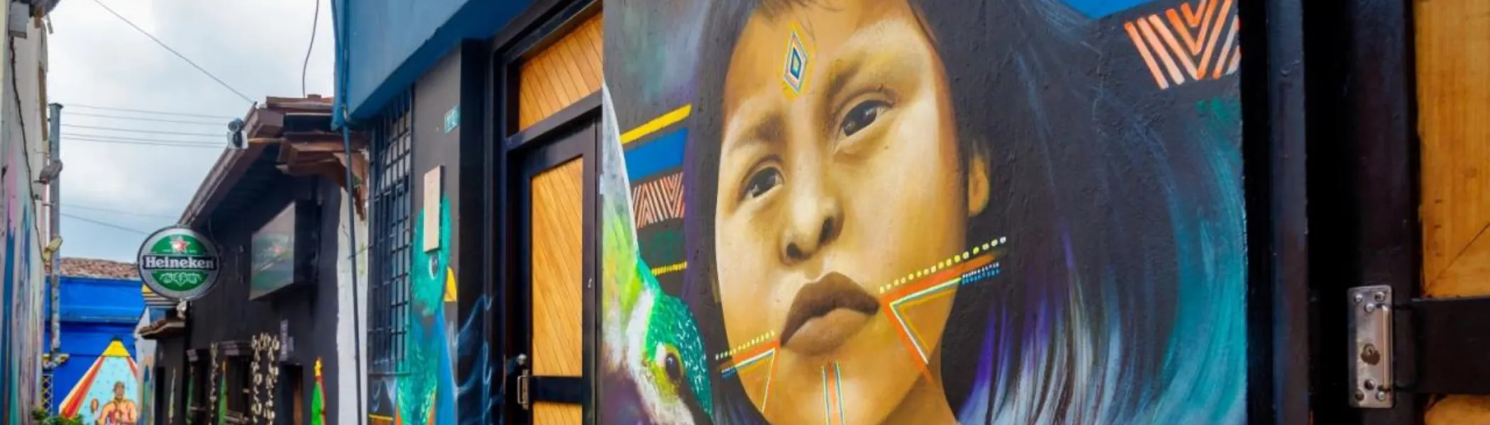 Painting on the side of the building, of a child.