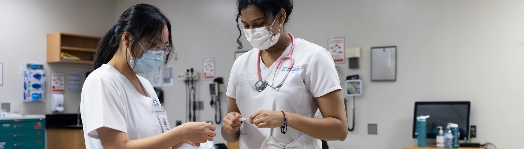 Trent University students in nursing lab, working togeter.
