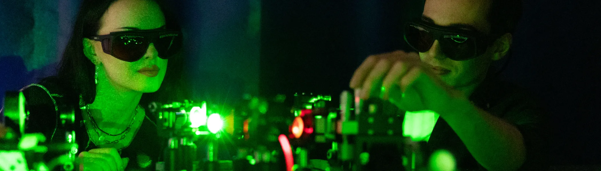 two students working in a laser lab together.