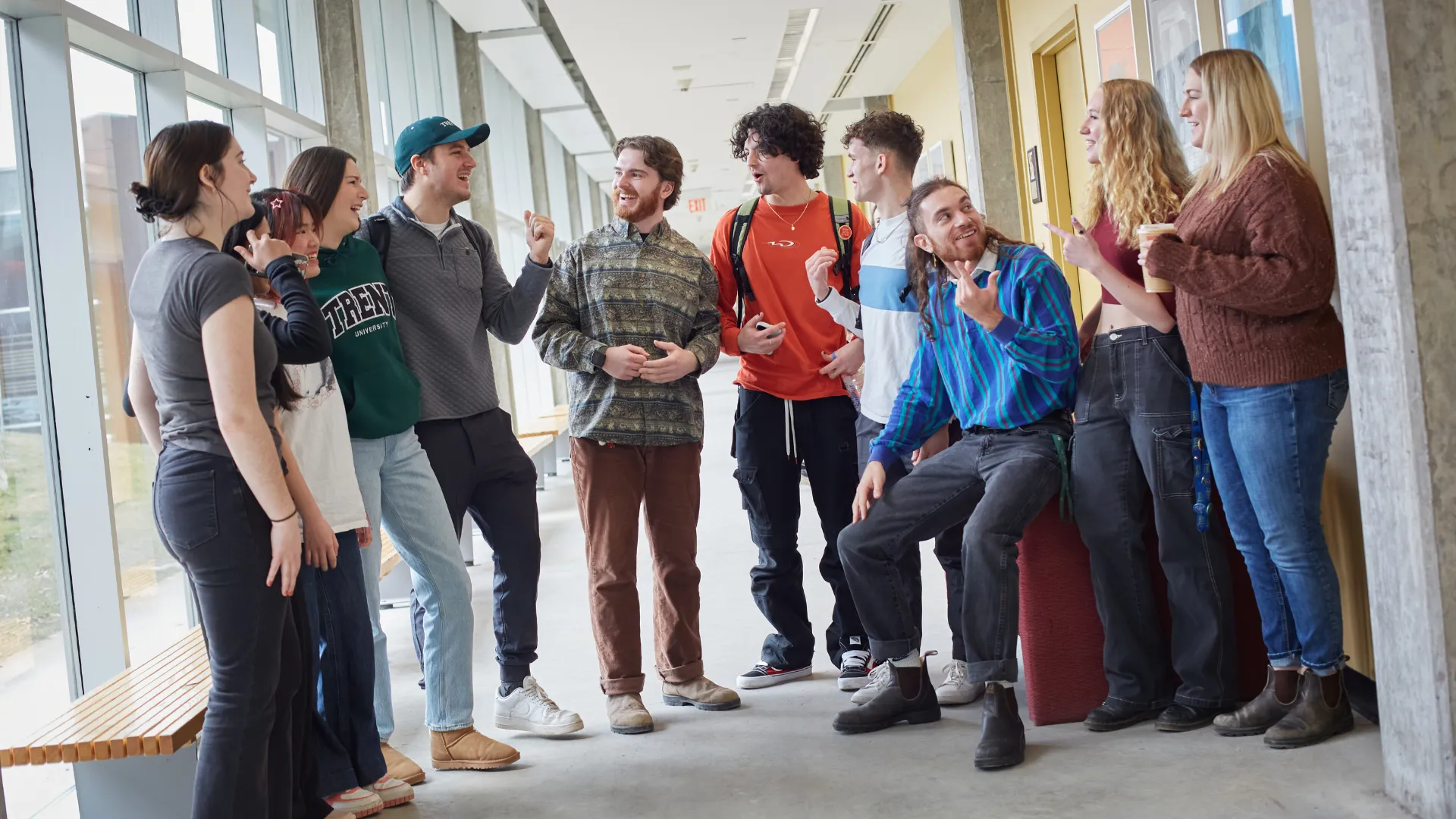 A group of Trent University students talking in Gzowski College's hallway.