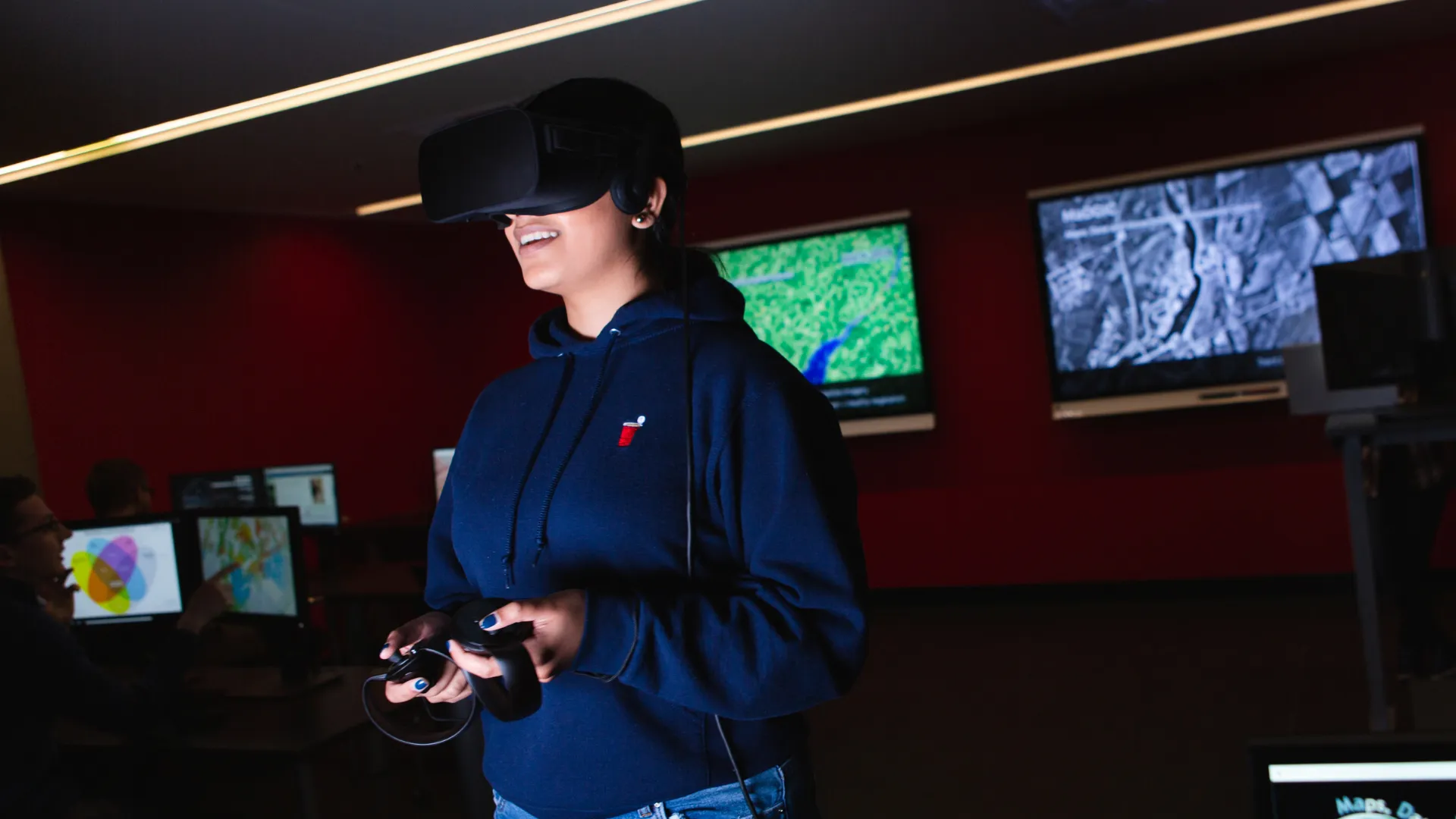 A Trent University student using VR headset, in Bata library.