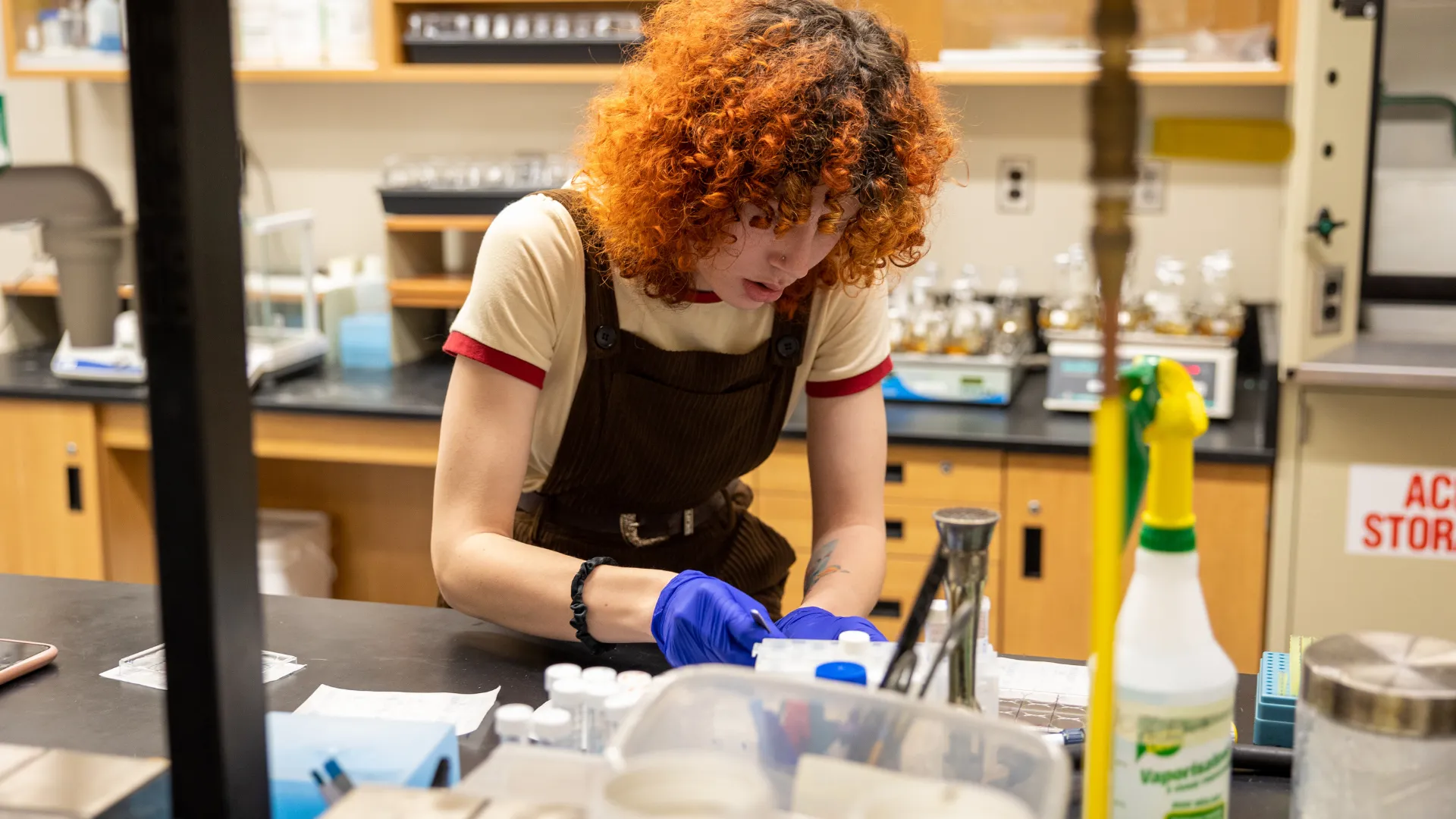 A Trent University student, conducting research in a lab.