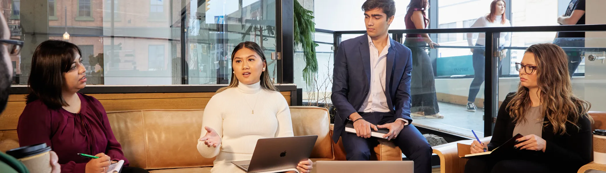 Two business students discussing ideas in meeting with two professionals.