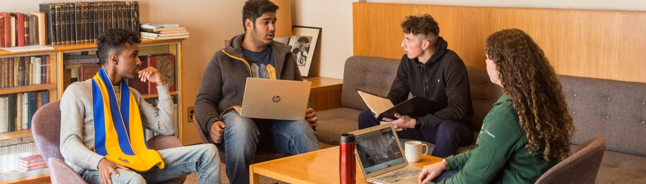 Trent University students working on a group project, on computers.