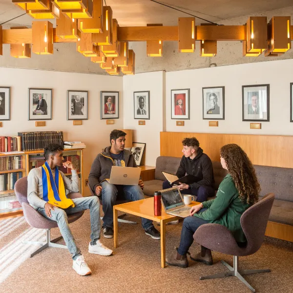 Trent University students working on a group project, on computers.