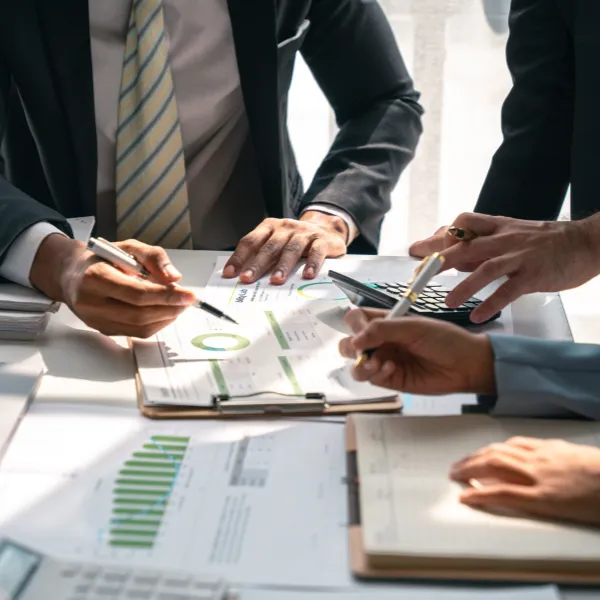 Economic concepts business partners looking at data analysis to determine business outcomes in the workplace.