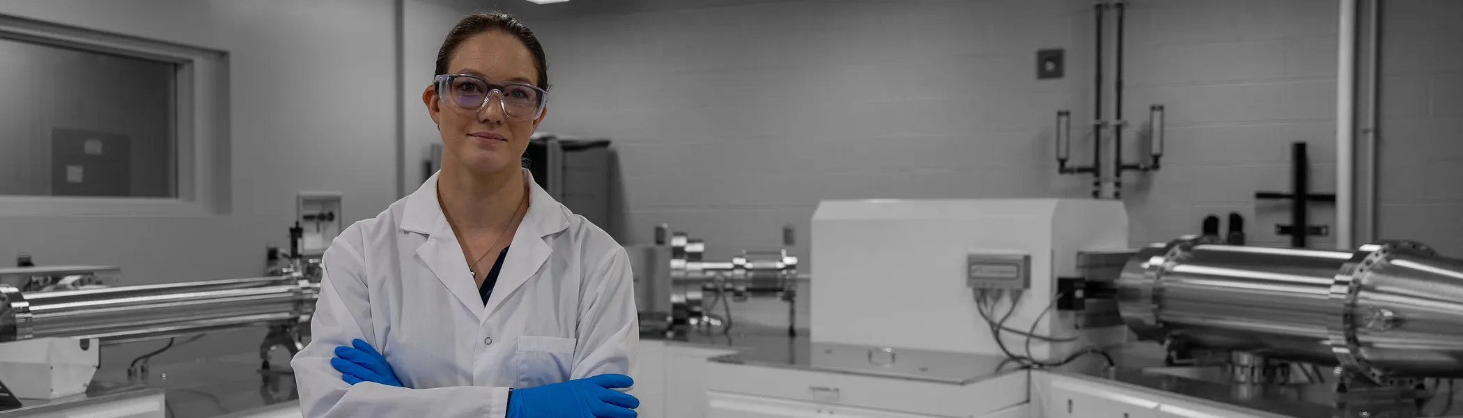 Trent University student, in lab, smiling at the camera.