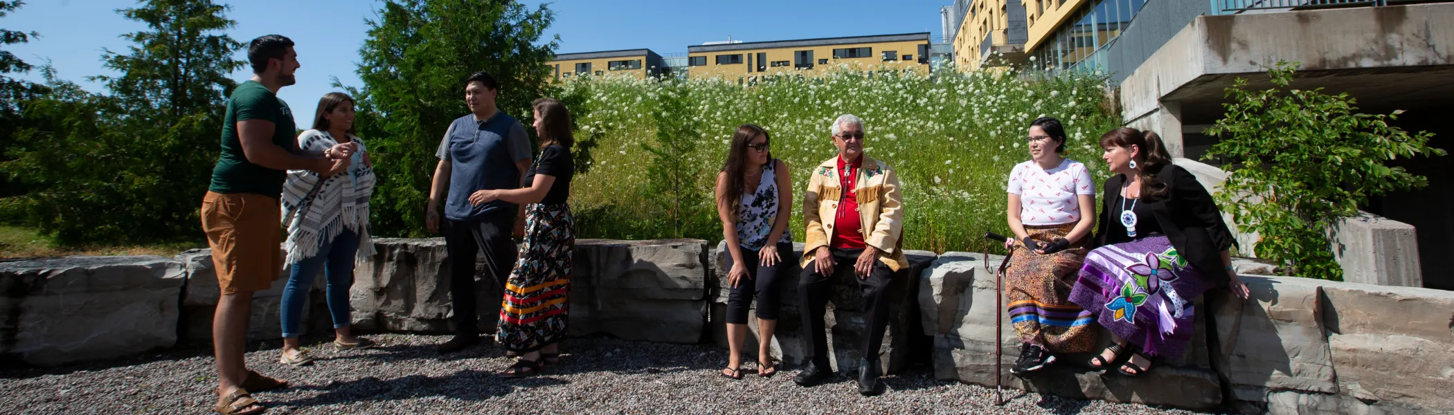 Trent University First Peoples House of Learning students and staff talking outside.