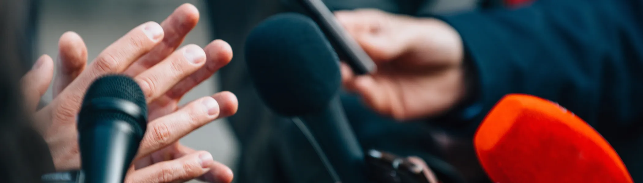 Interviewing business person at a press conference.