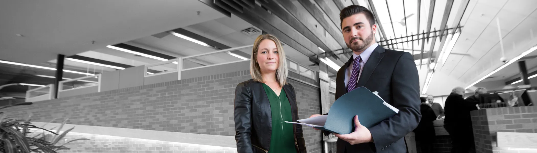 Image of two business people, looking at the camera.