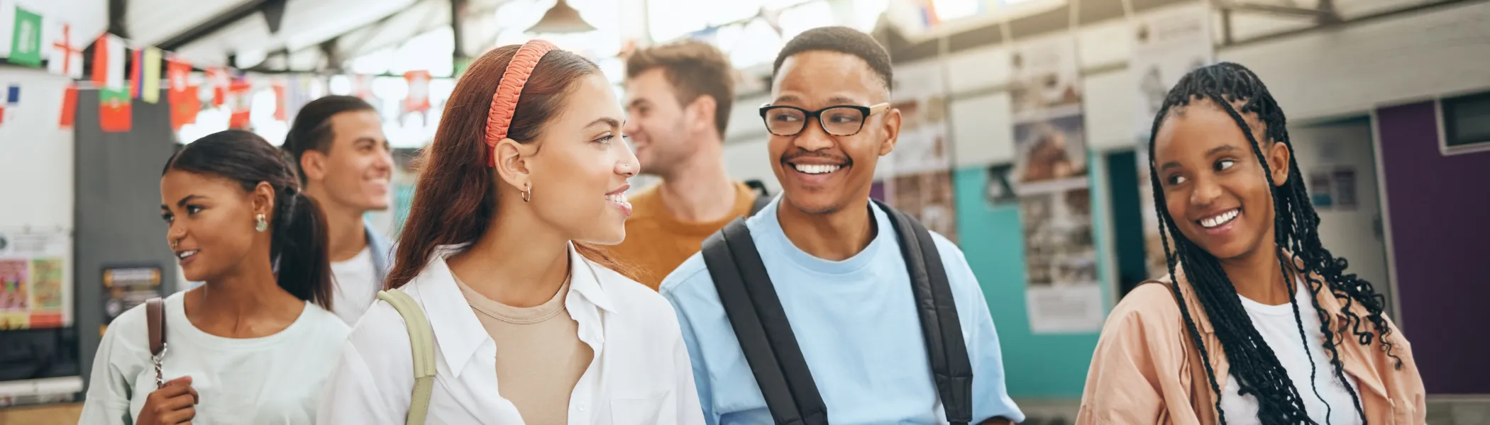 University students studying abroad, walking down a street talking.