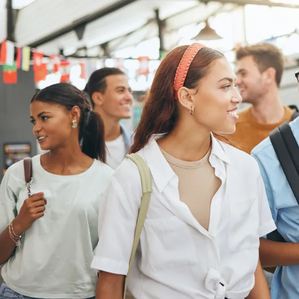 University students studying abroad, walking down a street talking.
