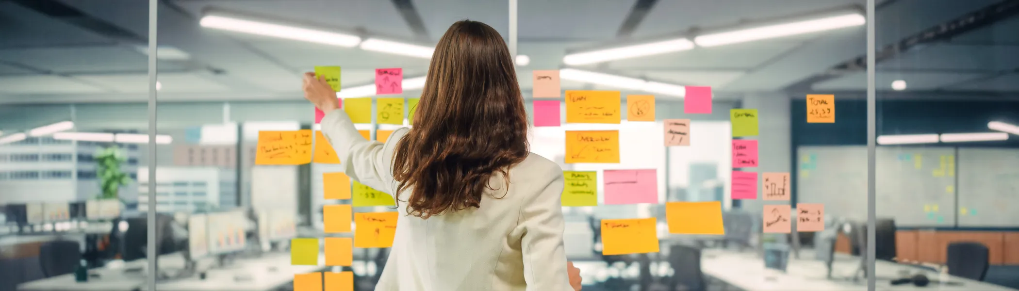 Business person creating marketing project plan on Office window with Paper Notes. 