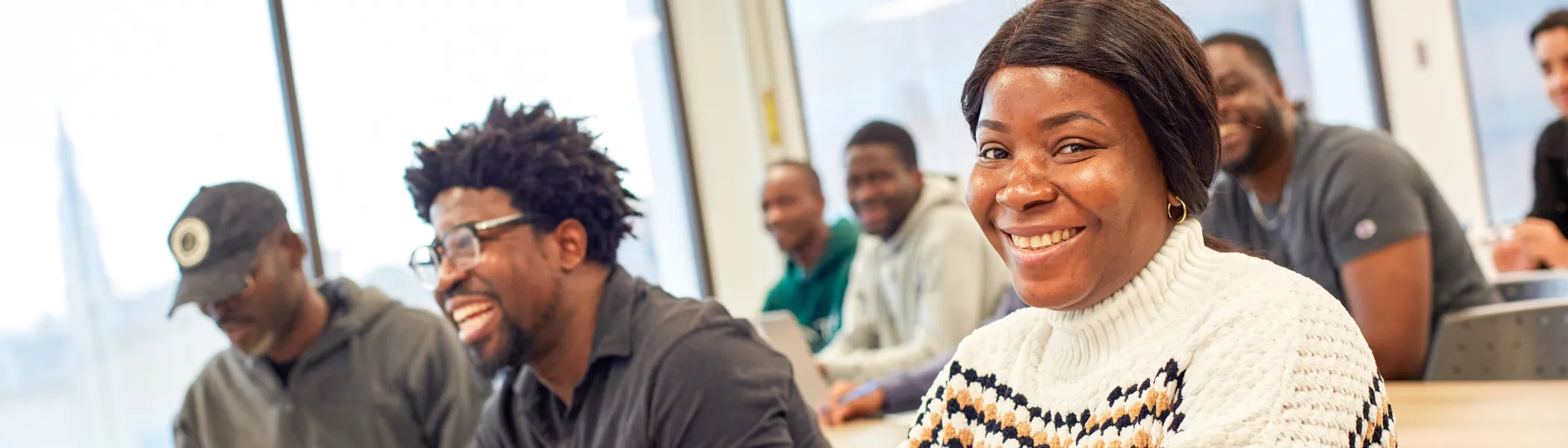 Trent University student, in class at the Advance Learning Centre, smiling at the camera.