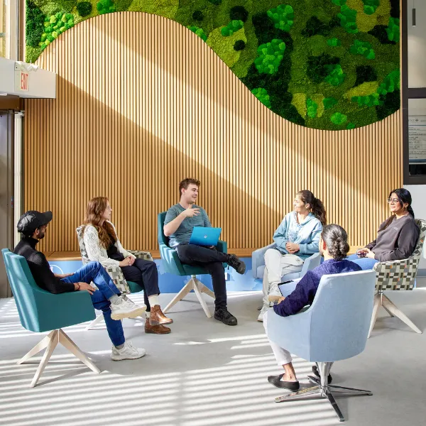 Group of Trent University students at the Advance Learning Centre, talking to each other.