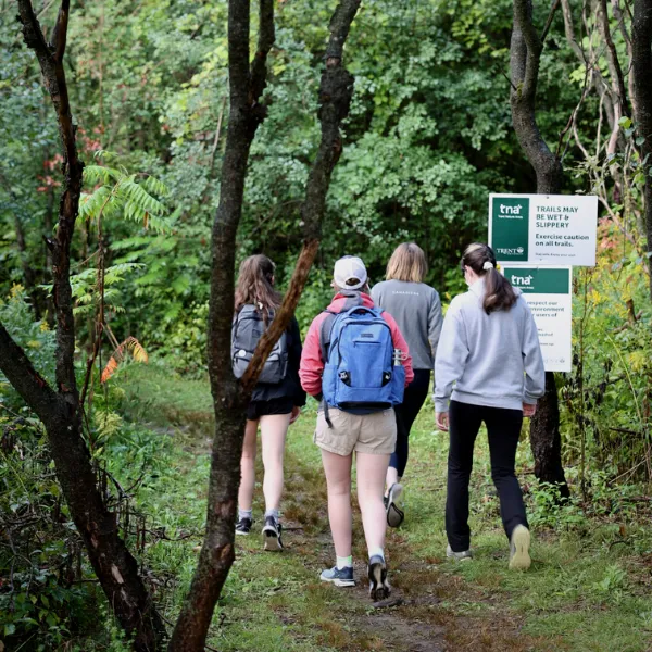Trent University students hiking in Trent Lands nature area's traills.