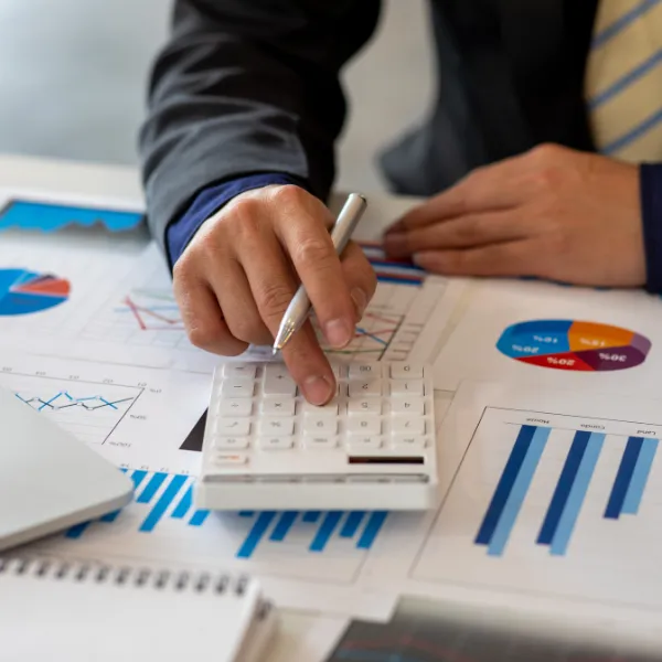 Close up Business person using calculator and laptop for do math finance.