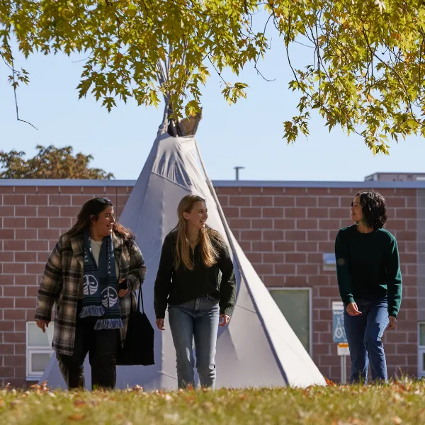 Trent University Durham students walking in front of tipi.