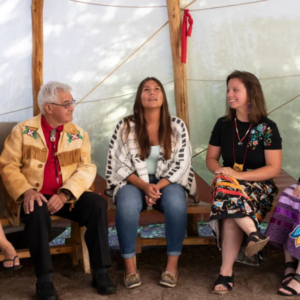 Trent University First Peoples House of Learning students and staff talking inside of Tipi.