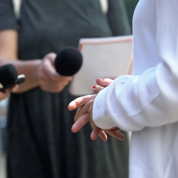 Close-up of woman hands during interview with media, press conference.
