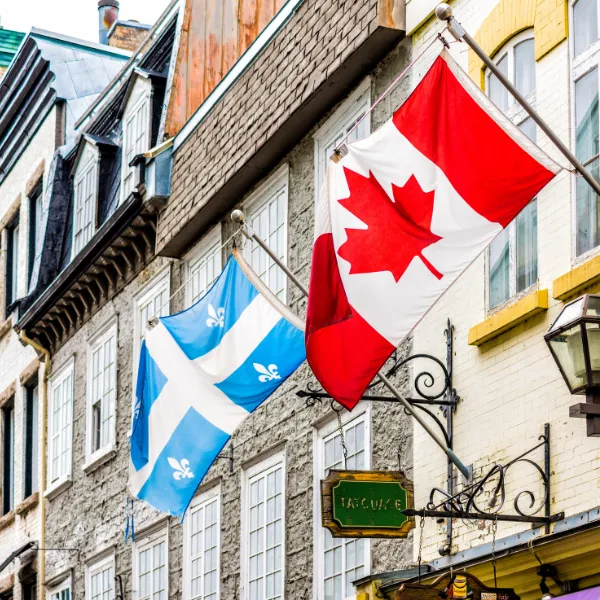 Quebec City, Canada, Tatouage Biron Fils flags sign for a restaurant in upper old town street called Rue Garneau.