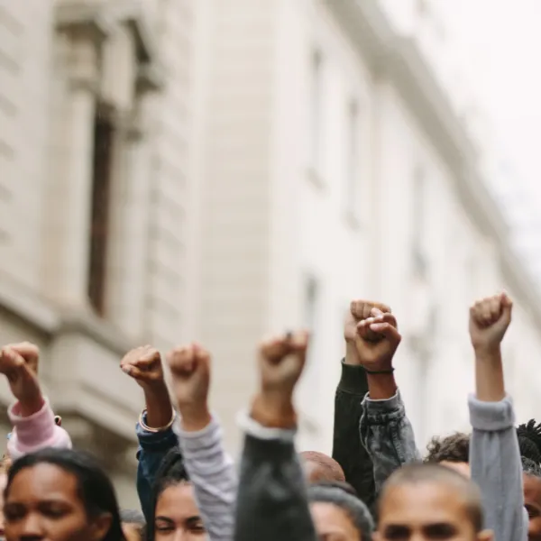 Group of protestors fists raised up in the air.