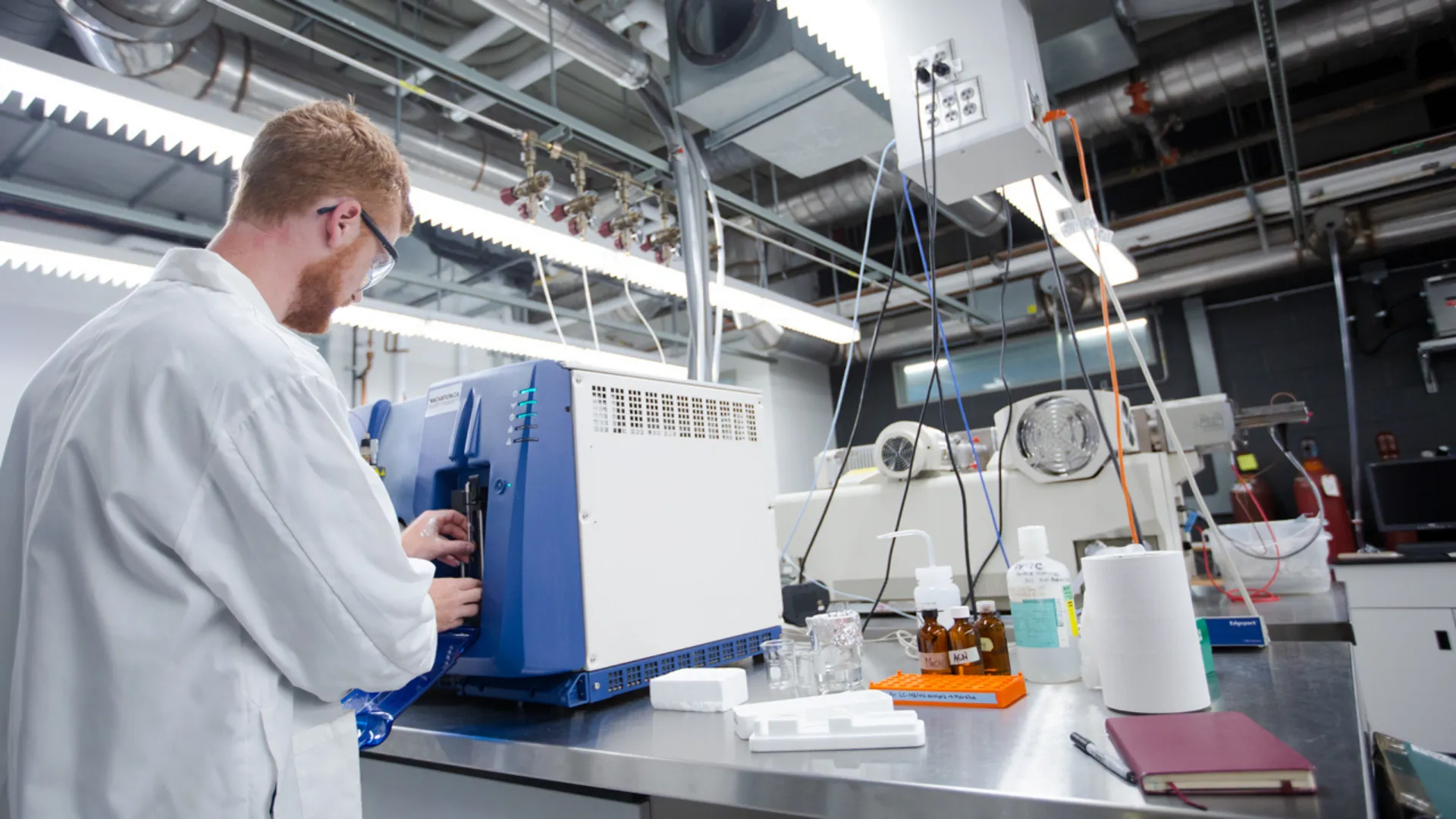 A Trent student prepares to a machine in a lab